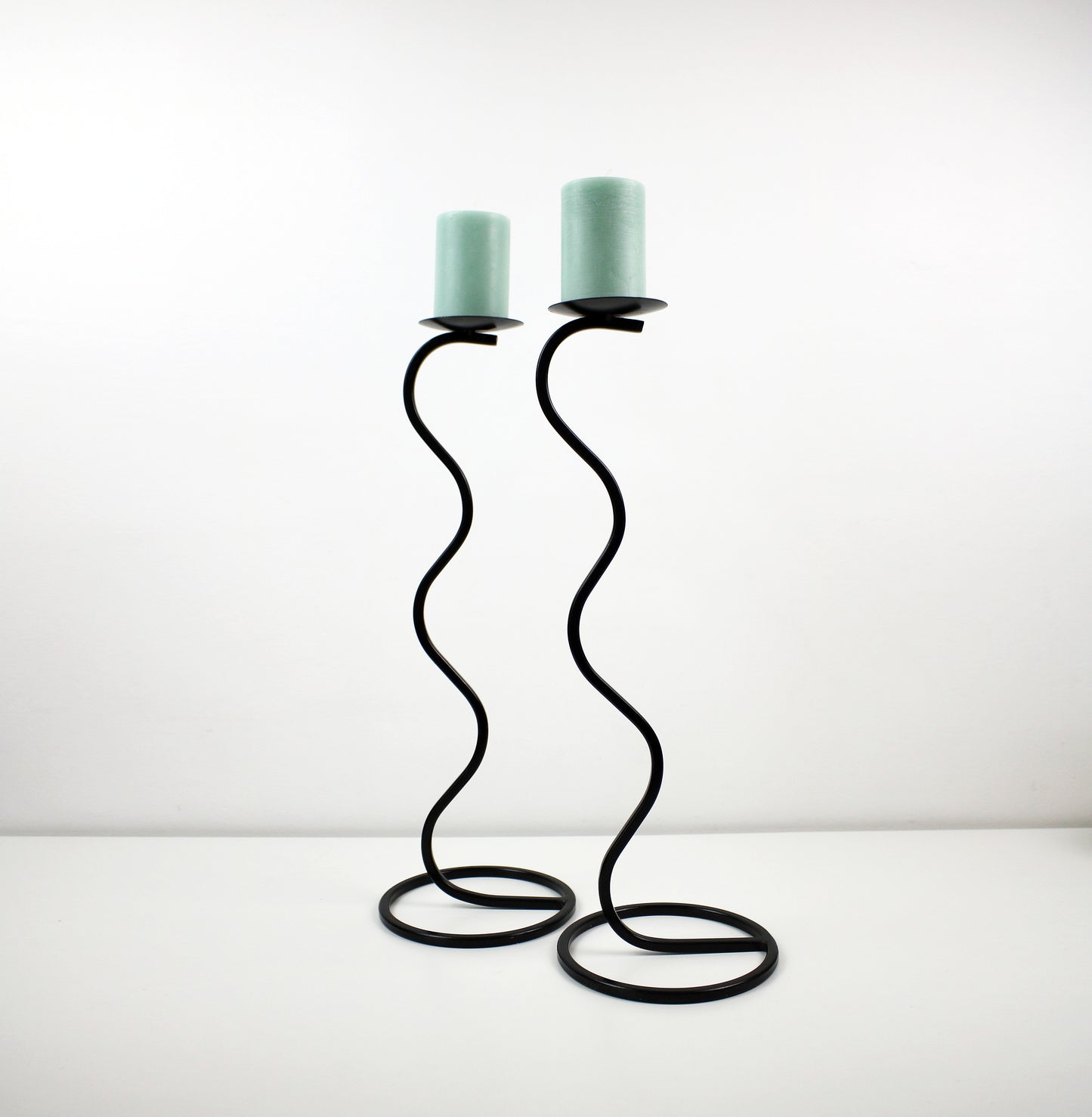 Pair of post modern floor standing wave squiggle iron candlesticks