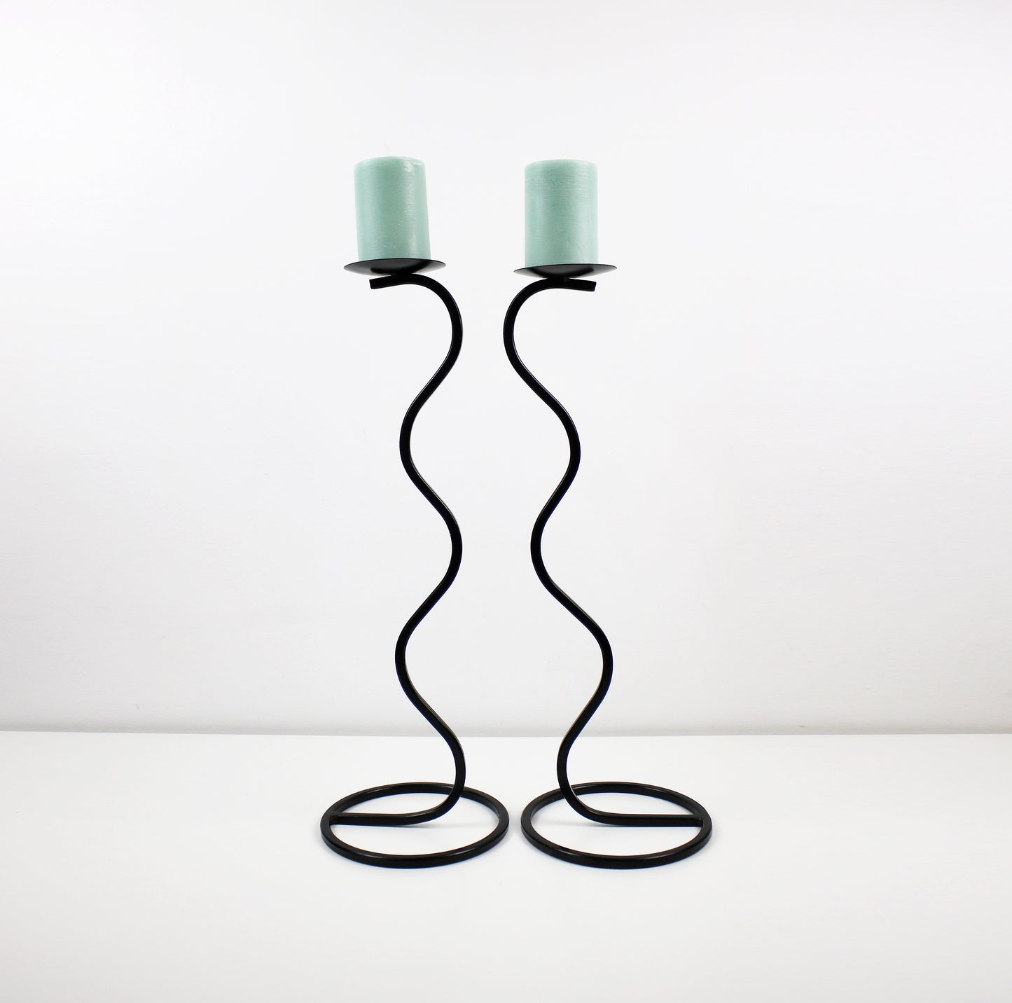 Pair of post modern floor standing wave squiggle iron candlesticks