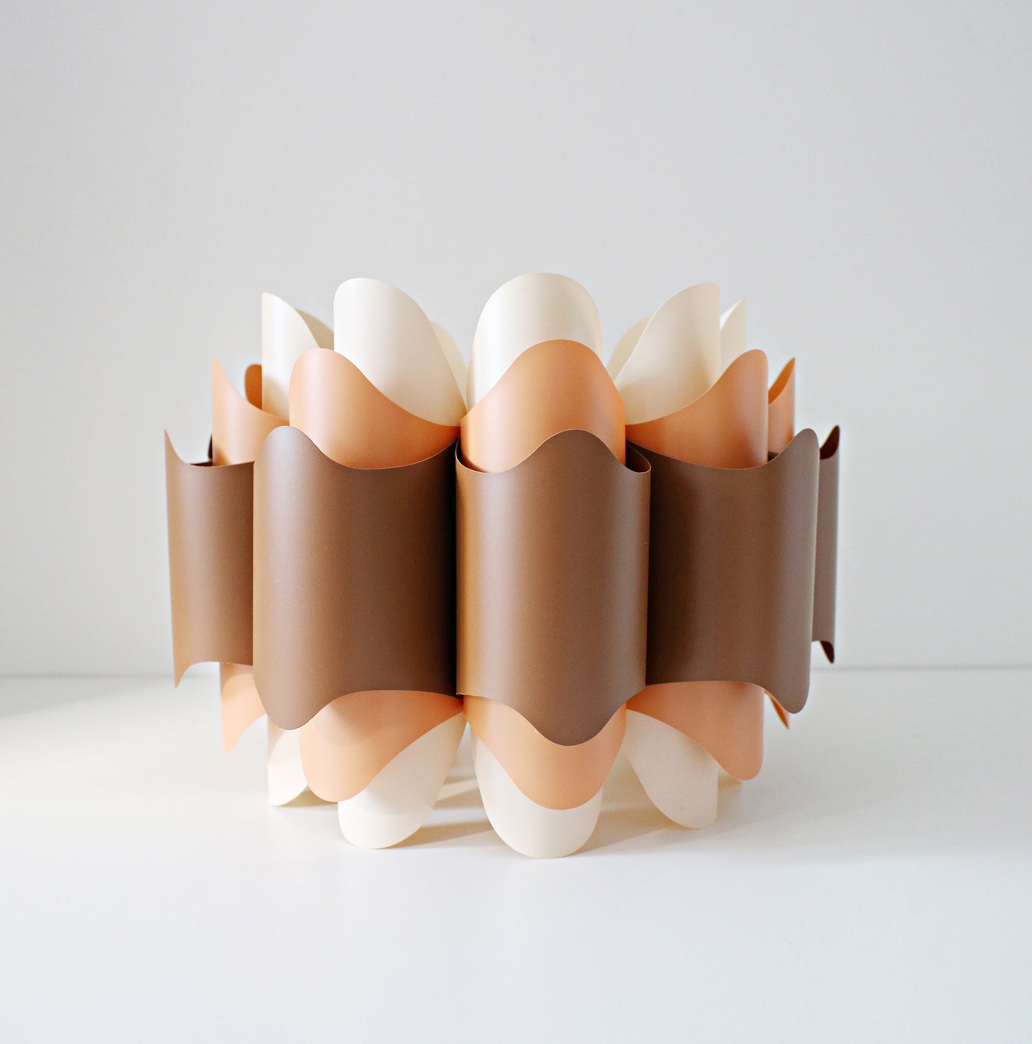 Rare 1970s ceiling lamp shade in (Hoyrup) tones of orange, brown and cream. Geometric modernist design in plastic