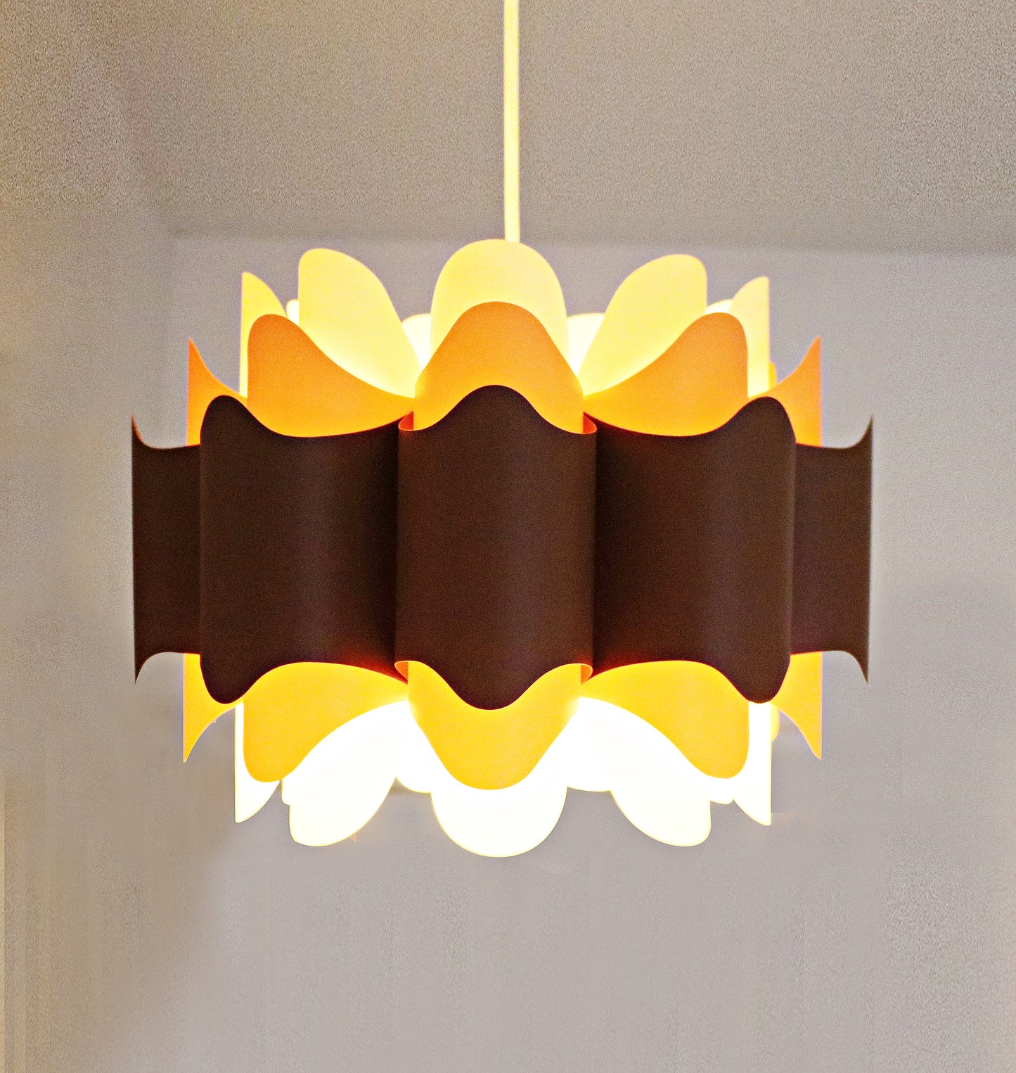 Rare 1970s ceiling lamp shade in (Hoyrup) tones of orange, brown and cream. Geometric modernist design in plastic