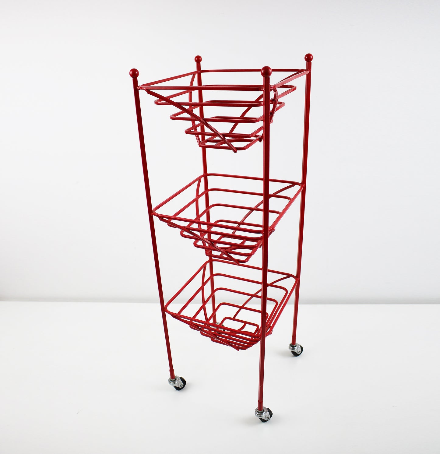 Preloved 3 tier fruit basket vegetable trolley - atomic revival red coated steel - late 20th centuryRed powder coated square tubular steel trolley with 3 fruit or vegetable baskets. Bobble detail at the top reminiscent of the atomic revival. Research suggests that this is either late 80s or 1990s Habitat but as yet unverified.