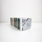 Silver CD holder with CDs on a white background