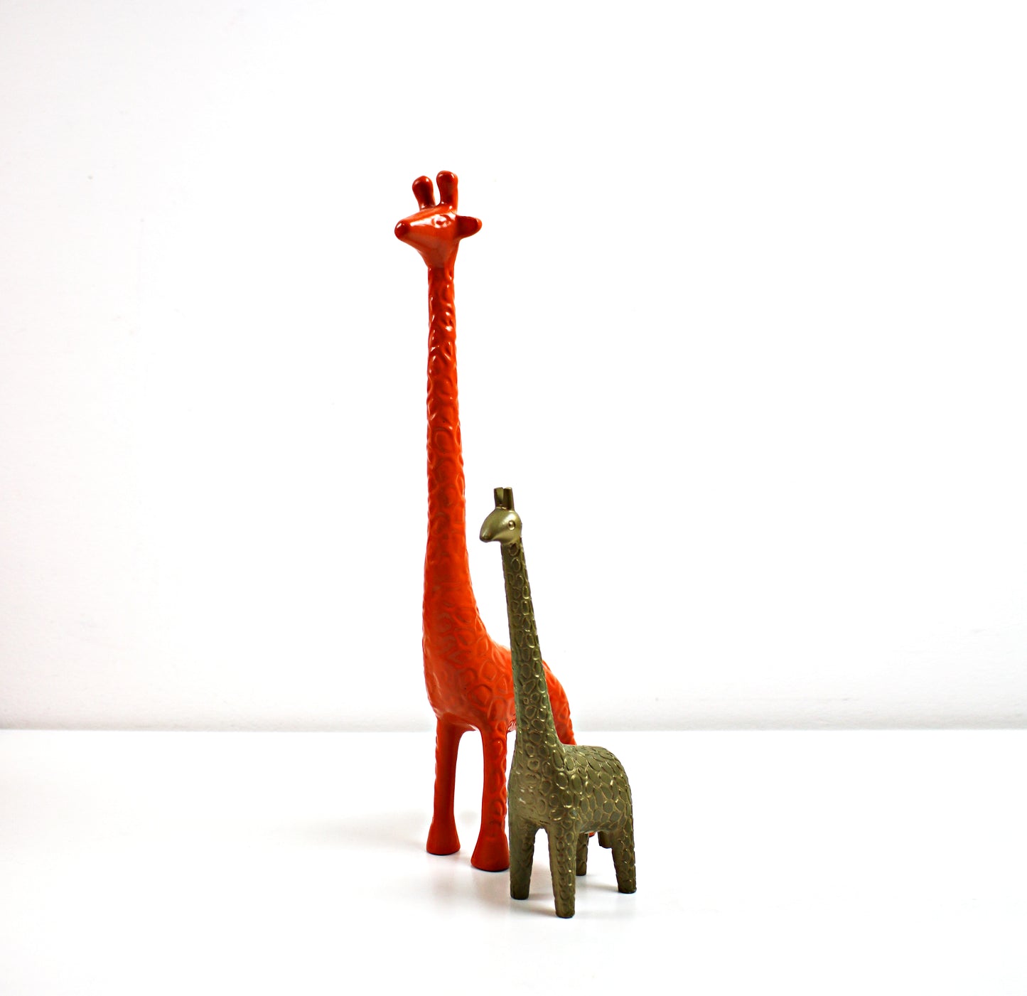 orange and bronze giraffe ornaments from habitat and ikea collectable metal and enamel figurines