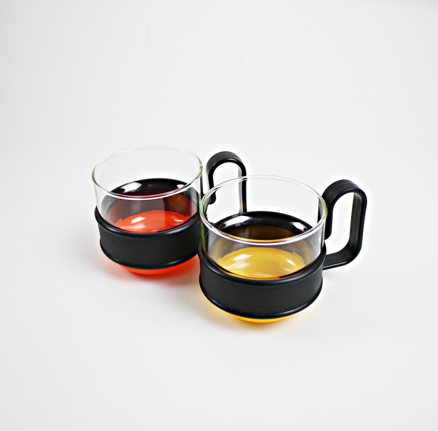 Pairs of modernist Pyrex Brasilia - glass and plastic cups - black and orange or black and yellow