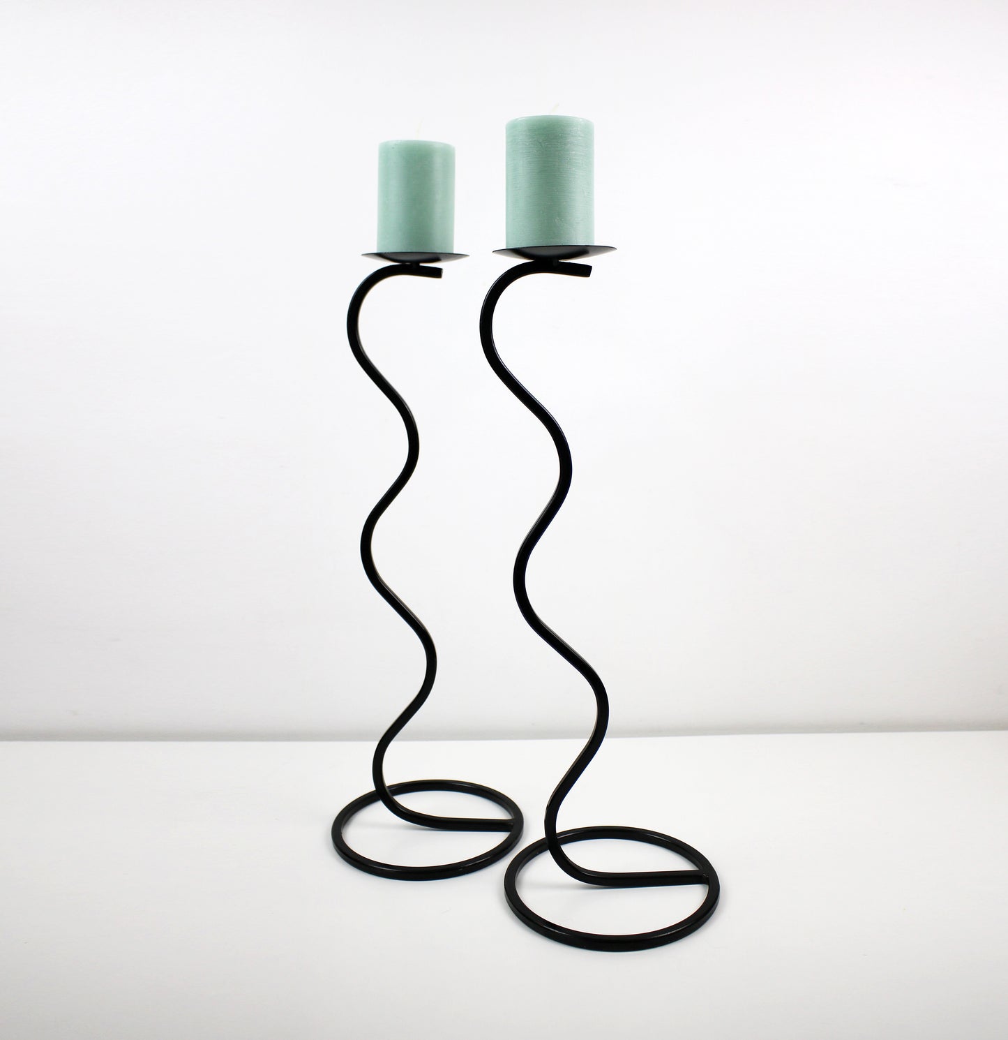 Pair of post modern floor standing wavy squiggle iron candlesticks candle holders