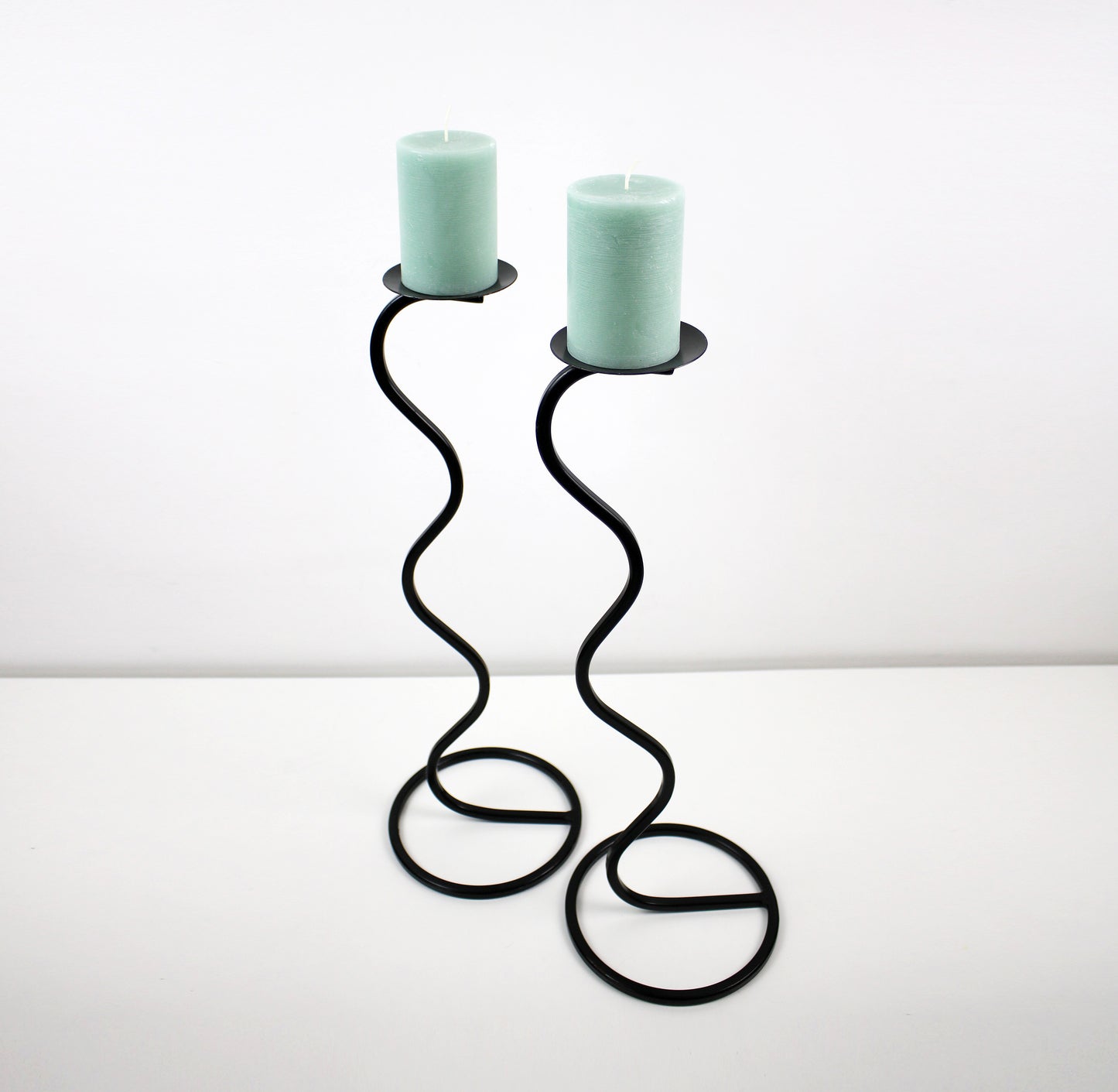 Pair of post modern floor standing wave squiggle iron candlesticks