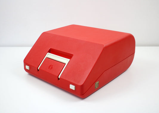 Vintage Olympia Monica portable typewriter with red keys and case