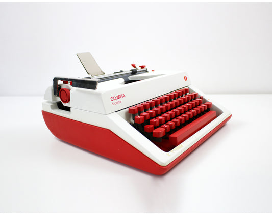 Vintage Olympia Monica portable typewriter with red keys and case